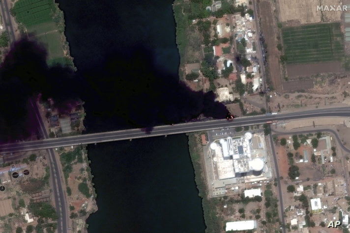 This satellite image provided by Maxar Technologies shows fires burning near a hospital in Khartoum, Sudan, Sunday April 16,…