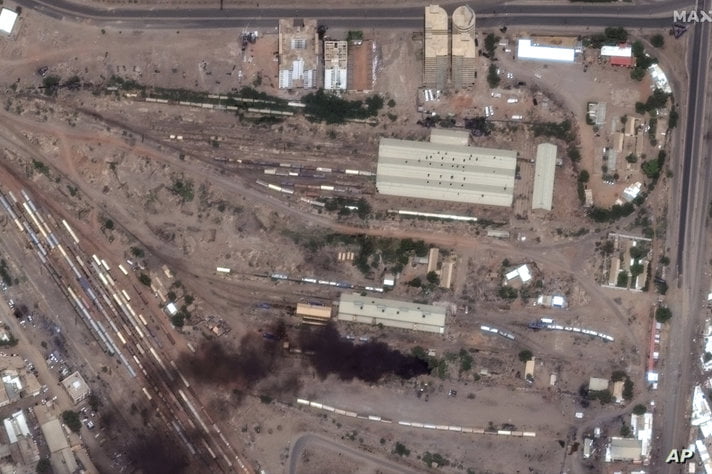 This satellite image provided by Maxar Technologies shows fires and smoke at Khartoum railway, Sudan, Sunday April 16, 2023…