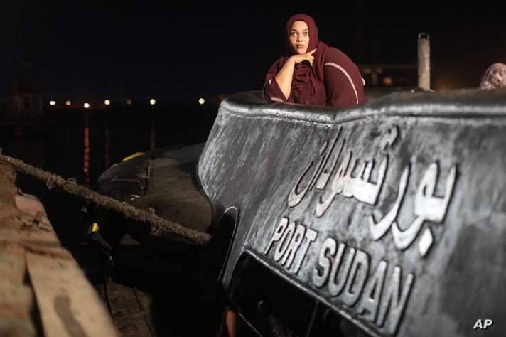 A Sudanese evacuee waits before boarding a Saudi military ship to Jeddah port, at Port Sudan in Sudan, Wednesday, May 3, 2023…